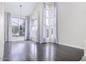 Bright living room with hardwood floors, high ceilings, large windows, and elegant curtains at 228 W Bolero Dr, Tempe, AZ 85284