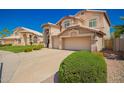 View of home's stucco exterior, tile roof, and manicured landscaping at 2741 N 137Th Ave, Goodyear, AZ 85395