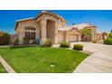 Manicured lawn and landscaping highlight the exterior of this lovely two-story home at 2741 N 137Th Ave, Goodyear, AZ 85395