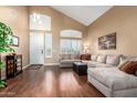 Spacious living room featuring hardwood floors, vaulted ceilings, and abundant natural light at 2741 N 137Th Ave, Goodyear, AZ 85395