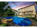 Backyard with a large blue pool, lounge chairs and a covered patio with sliding glass doors to the home at 3535 E Crescent Way, Gilbert, AZ 85298