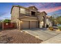 Two story home with three car garage, gravel landscaping, and view of the balcony above the garage at 3535 E Crescent Way, Gilbert, AZ 85298