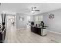 Home office with tile floors, modern ceiling fan, accent mirror and a large desk with black desktop at 3535 E Crescent Way, Gilbert, AZ 85298