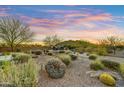 Expansive desert landscaped backyard with cacti and native plants, plus an outdoor seating area and mountain views at 37170 N Greythorn Cir, Carefree, AZ 85377
