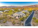 Aerial shot of a home nestled in a desert community, showcasing the home's backyard with desert landscaping at 37170 N Greythorn Cir, Carefree, AZ 85377