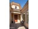 Cozy front entry with a charming bench, flower pot, and beautiful accent windows showcasing the architecture at 3822 E Tracker Trl, Phoenix, AZ 85050