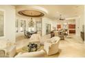 An elegant dining area that is open to the living room, with a decorative ceiling and natural light at 3822 E Tracker Trl, Phoenix, AZ 85050