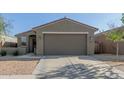 Close up front exterior view of single story home with a well maintained yard and neutral color paint at 40467 W Jenna Ln, Maricopa, AZ 85138