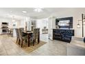 Dining room features tile floors, a modern table set, and french door access to the Gathering room at 4734 E Florian Cir, Mesa, AZ 85206