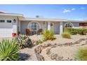 Charming single-story home with brick accents, desert landscaping and inviting front sitting area at 4734 E Florian Cir, Mesa, AZ 85206