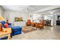 Spacious living room with tile floors, ceiling fan and comfortable seating area with views to dining and kitchen at 4734 E Florian Cir, Mesa, AZ 85206