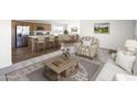 Inviting living room showcases an open concept to the kitchen with modern finishes and stainless steel appliances at 50426 W Wildwood Rd, Maricopa, AZ 85139