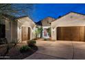 Charming home featuring a three-car garage, desert landscaping and a brick-paved driveway at 5448 E Windstone Trl, Cave Creek, AZ 85331