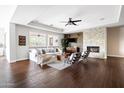 Cozy living room with a stone fireplace, hardwood floors, and stylish decor at 5448 E Windstone Trl, Cave Creek, AZ 85331