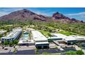 An aerial view showcases the community pool and resort-style amenities with mountain views at 5455 E Lincoln Dr # 3008, Paradise Valley, AZ 85253