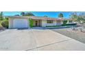 Attractive single-story home featuring a large driveway and desert-friendly landscaping at 5811 E Edgemont Ave, Scottsdale, AZ 85257