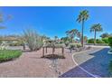 Desert landscaped yard with a decorative rock stream and a small wooden bridge detail at 5811 E Edgemont Ave, Scottsdale, AZ 85257