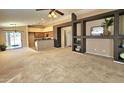 Spacious open-concept living room featuring neutral carpet, decorative shelving and a view of the kitchen at 592 E 9Th Ave, Apache Junction, AZ 85119