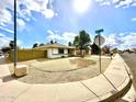 A well-kept property sits on a corner lot with gravel landscaping and block wall at 6201 W Acoma Dr, Glendale, AZ 85306