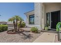 Close up of the front door and garden area in xeriscaped yard with desert foliage at 6334 E Viewmont Dr # 29, Mesa, AZ 85215