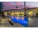 Luxurious backyard pool illuminated against a vibrant dusk sky, offering a serene oasis at 7380 E Turquoise Ave, Scottsdale, AZ 85258