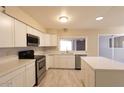 Bright kitchen features white cabinets, stainless steel appliances, and a modern backsplash at 8666 E Fillmore St, Scottsdale, AZ 85257
