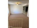 Spacious living room features plush carpeting and a ceiling fan at 10014 N 44Th Dr, Glendale, AZ 85302