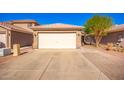 Attached two-car garage with a clean, neutral door and well-maintained exterior, set in a sunny neighborhood at 11226 W Glenrosa Ave, Phoenix, AZ 85037