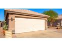 Spacious two-car garage featuring a clean, neutral door, well-maintained exterior, and desert landscaping at 11226 W Glenrosa Ave, Phoenix, AZ 85037