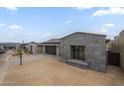 Beautiful exterior of home with gray stone, tile roof, and landscaping at 12326 E Black Rock Rd, Scottsdale, AZ 85255