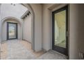 Charming front porch with arched entryway and tiled floor at 12326 E Black Rock Rd, Scottsdale, AZ 85255
