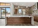 Spacious kitchen with modern quartz island and wood cabinetry at 12416 N 65Th Pl, Scottsdale, AZ 85254