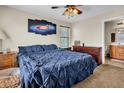 Inviting bedroom with cozy blue bedding, wood furnishings, and ambient natural light at 1265 S Aaron St # 285, Mesa, AZ 85209