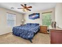 Relaxing bedroom featuring a plush blue bed, coordinating artwork, and natural light at 1265 S Aaron St # 285, Mesa, AZ 85209