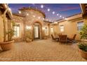 Inviting courtyard featuring a stone accent wall, cozy seating area, and elegant lighting, perfect for outdoor enjoyment at 1708 W Gambit Trl, Phoenix, AZ 85085