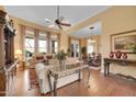 Bright and airy living room featuring hardwood floors, large windows, and stylish furnishings, creating an inviting atmosphere at 1708 W Gambit Trl, Phoenix, AZ 85085