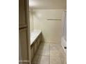 Bathroom featuring a single sink, tiled floor, tub, and overhead mirror at 18239 N 40Th St # 115, Phoenix, AZ 85032