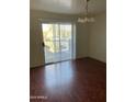 Dining room features wood-look floors and sliding glass doors to an outdoor balcony at 18239 N 40Th St # 115, Phoenix, AZ 85032