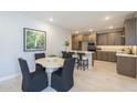 Bright dining area adjacent to a gourmet kitchen features stylish decor and modern lighting at 2121 W Sonoran Desert Dr # 95, Phoenix, AZ 85085