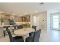 Open-concept kitchen and dining area are perfect for entertaining, complemented by neutral colors at 2121 W Sonoran Desert Dr # 95, Phoenix, AZ 85085