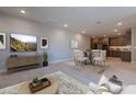 Open-concept living area with dining space, seamlessly connected to a modern kitchen featuring wood cabinetry at 2121 W Sonoran Desert Dr # 95, Phoenix, AZ 85085