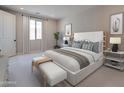 Serene main bedroom showcases a plush bed, elegant decor, and a window providing natural light at 2121 W Sonoran Desert Dr # 95, Phoenix, AZ 85085