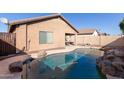 Backyard with a sparkling blue pool, rock accents and patio at 2187 W Kristina Ave, Queen Creek, AZ 85144