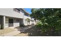 Exterior view of a two-story apartment building with a walkway and some mature trees providing shade at 2616 W Berridge Ln # C2, Phoenix, AZ 85017