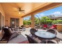 Covered patio featuring wicker seating, ceiling fan, and a view of the backyard at 26293 W Runion Ln, Buckeye, AZ 85396