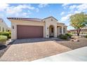 Well-maintained single-story home with desert landscaping and a brick driveway at 26797 W Sierra Pinta Dr, Buckeye, AZ 85396