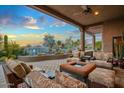 Covered patio showcasing comfortable seating and relaxing water feature, ideal for outdoor living at 40545 N 109Th Pl, Scottsdale, AZ 85262