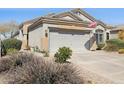 Inviting home exterior featuring a two-car garage and attractive desert landscaping at 4308 E Smokehouse Trl, Cave Creek, AZ 85331