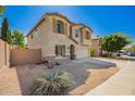 Tan two-story home featuring desert landscaping and a driveway at 4617 S Carmine --, Mesa, AZ 85212