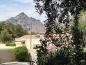 Scenic home exterior boasts mountain views, a red tile roof and is surrounded by lush landscaping at 5132 N 31St Way # 127, Phoenix, AZ 85016